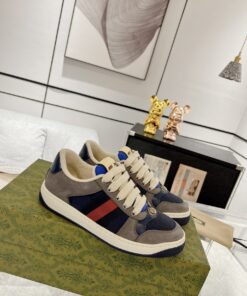 Low-top paneled suede and canvas sneakers in navy and gray.